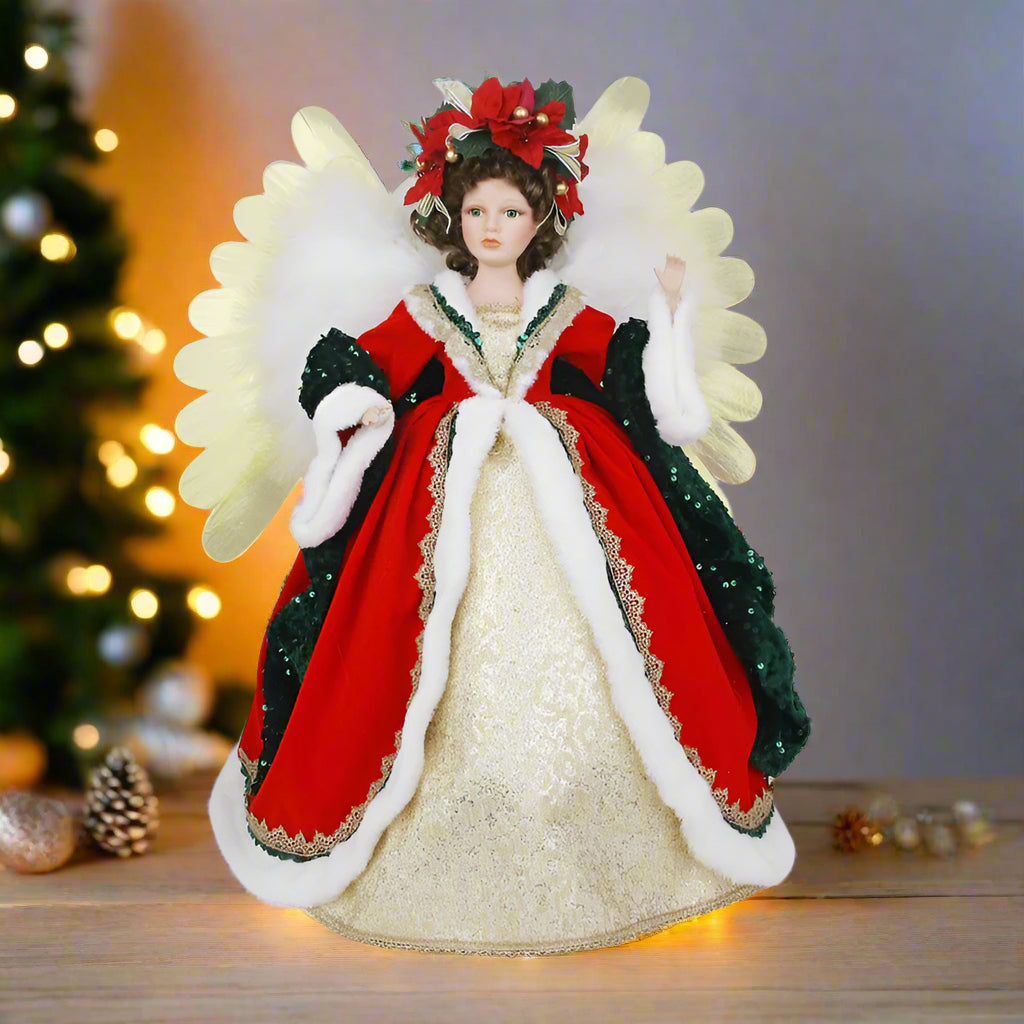Decorative angel figurine with red and gold attire on a white background