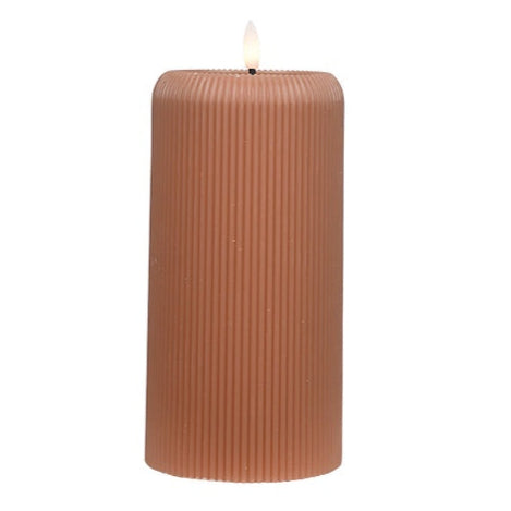 Brown ribbed candle on a white background