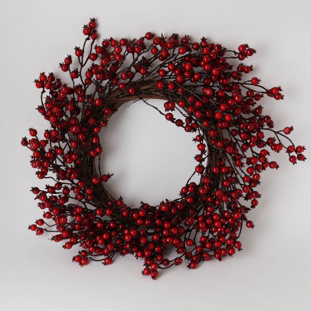 Decorative wreath with red berries on a white background