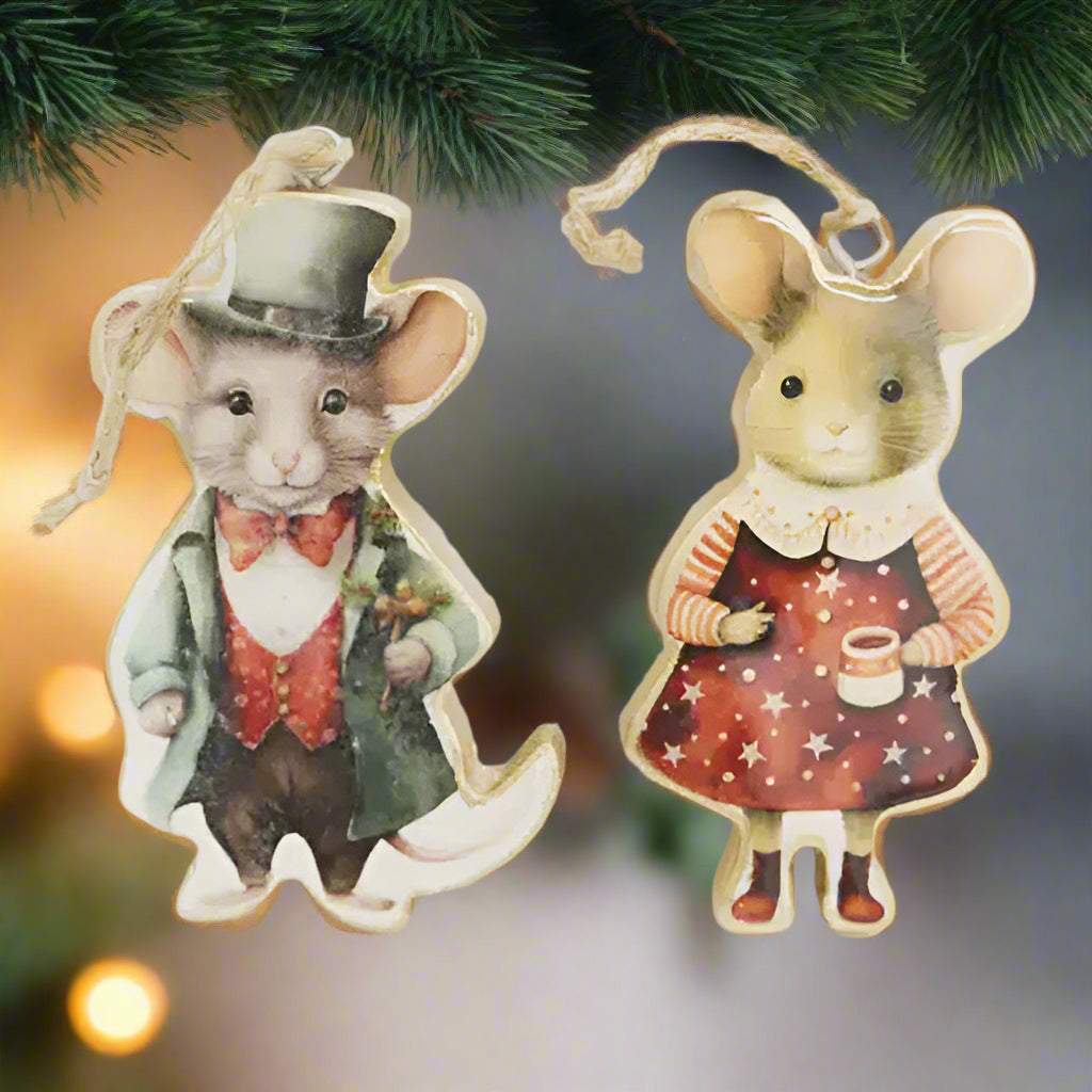 Two decorative mouse figurines, one in formal attire and the other in a dress with star pattern, on a light background.