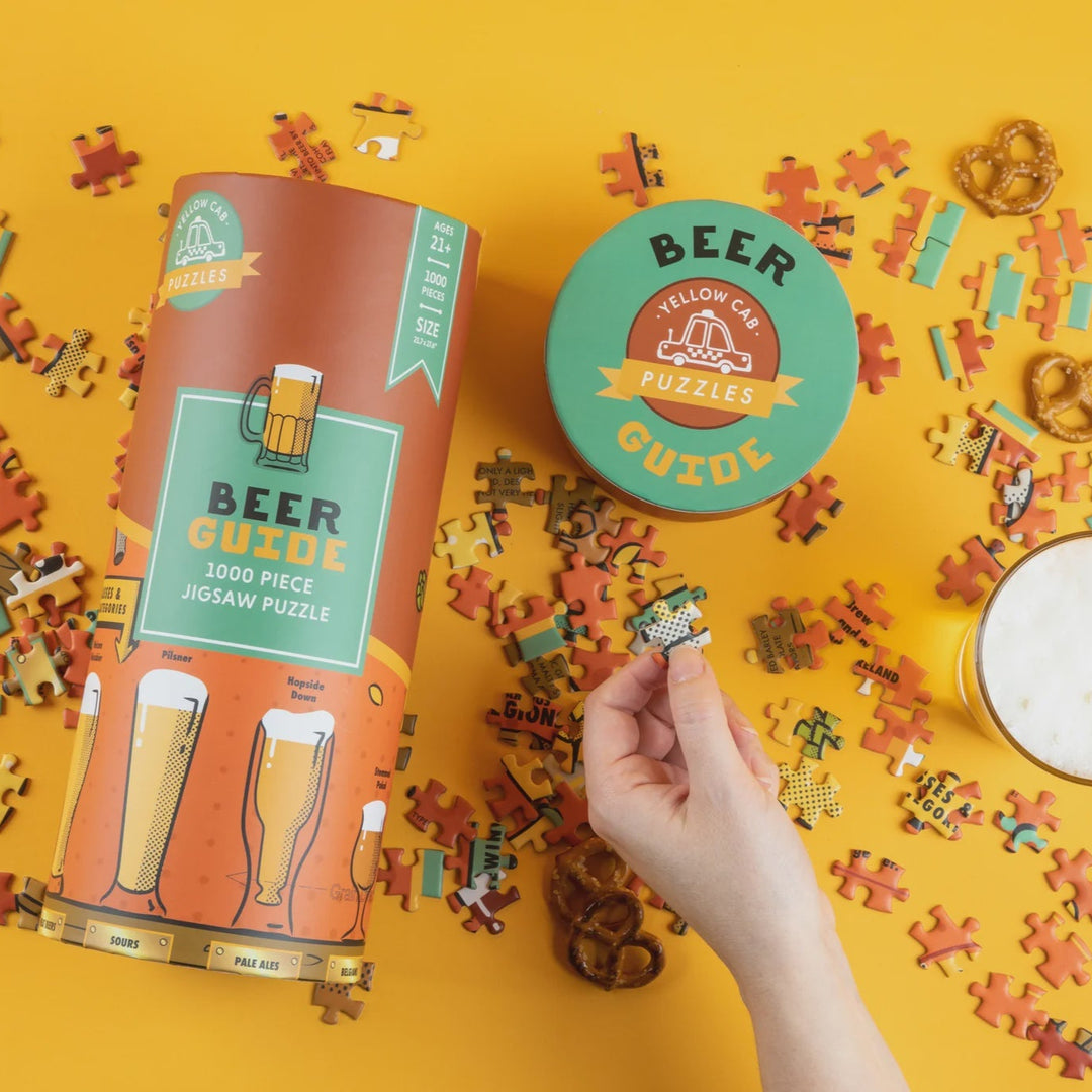 Beer-themed puzzle set with packaging and scattered pieces on a yellow background