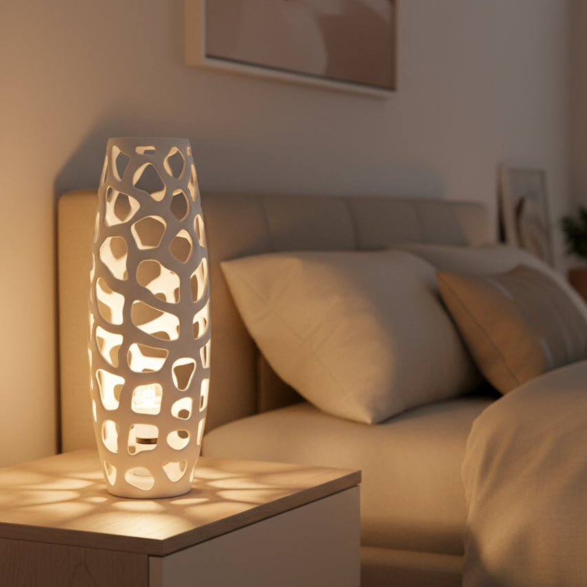 White decorative vase with a lattice design on a white background