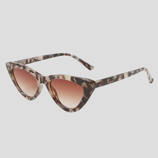 Cat-eye sunglasses with tortoiseshell frame and brown gradient lenses on a light gray background
