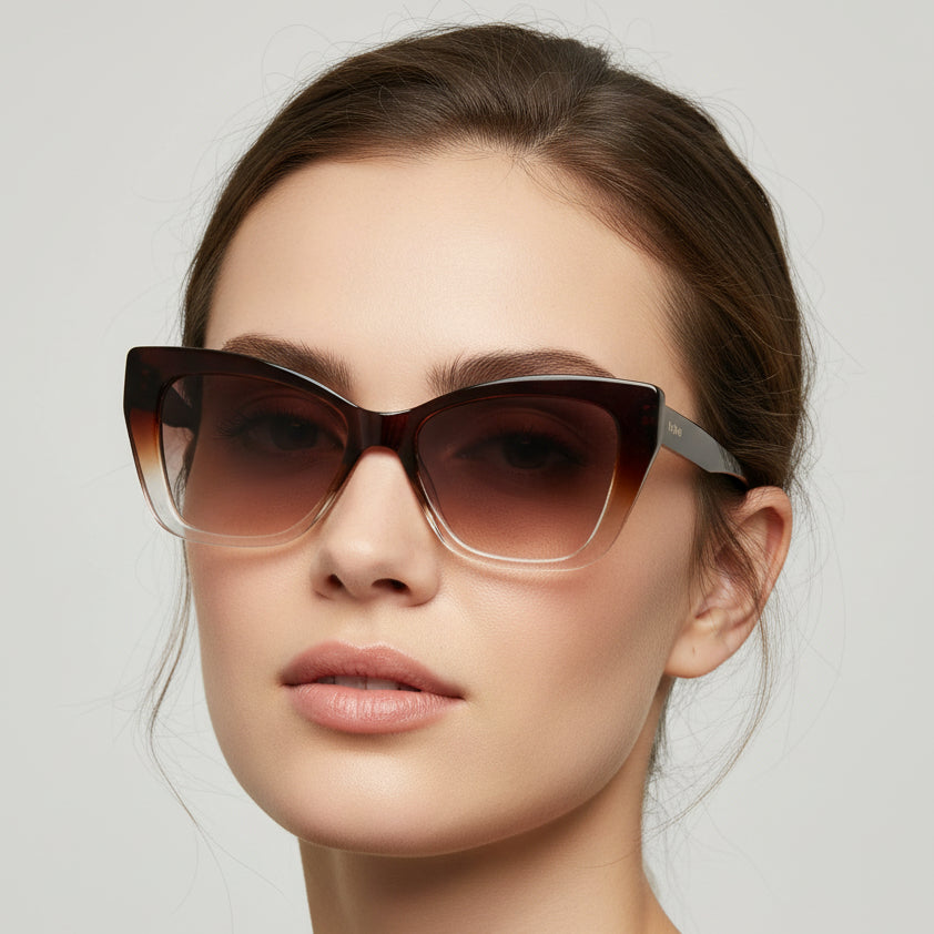 Cat-eye sunglasses with gradient lenses on a light gray background