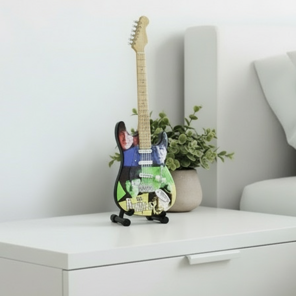 Fender Stratocaster guitar with The Beatles artwork on a white background