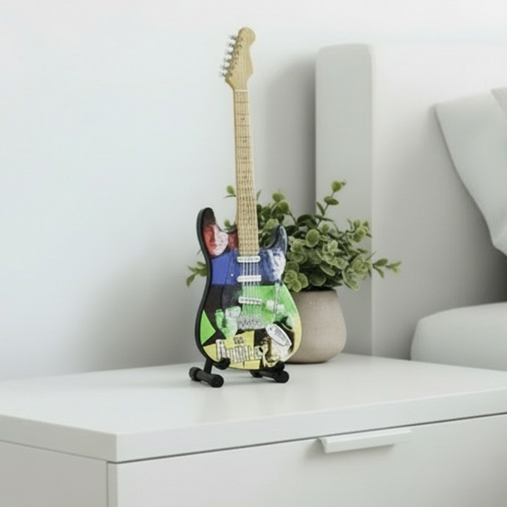 Fender Stratocaster guitar with The Beatles artwork on a white background