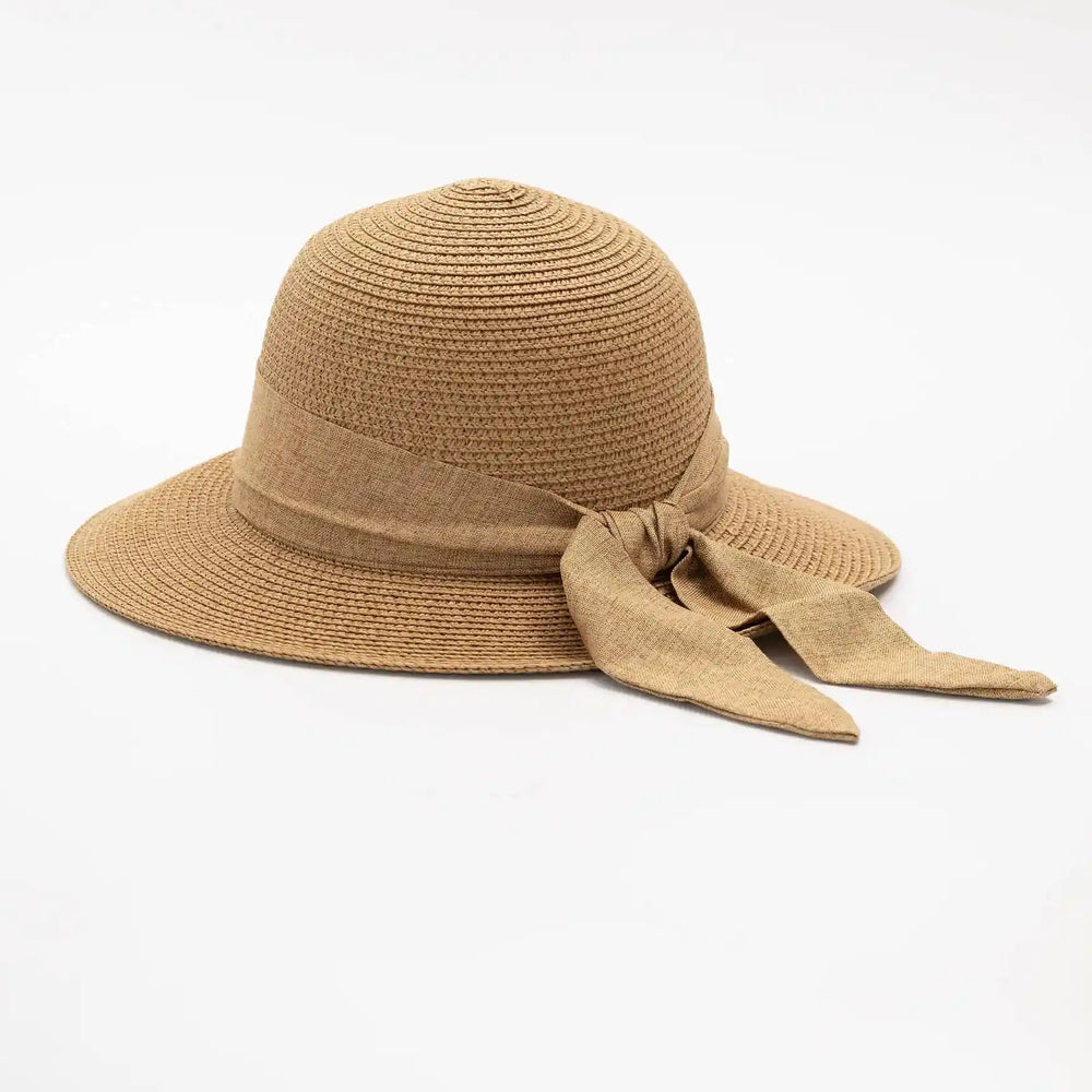 Beige straw hat with a bow on a white background