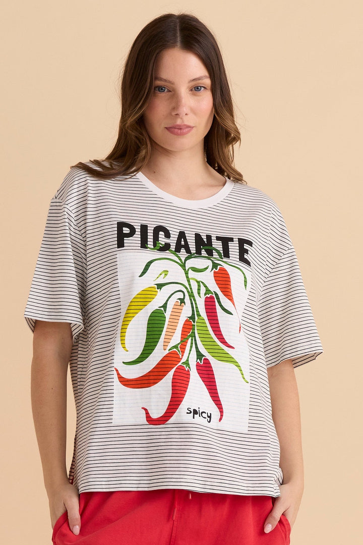 Woman wearing a striped betty basics t-shirt with a graphic chilli design and text on a beige background