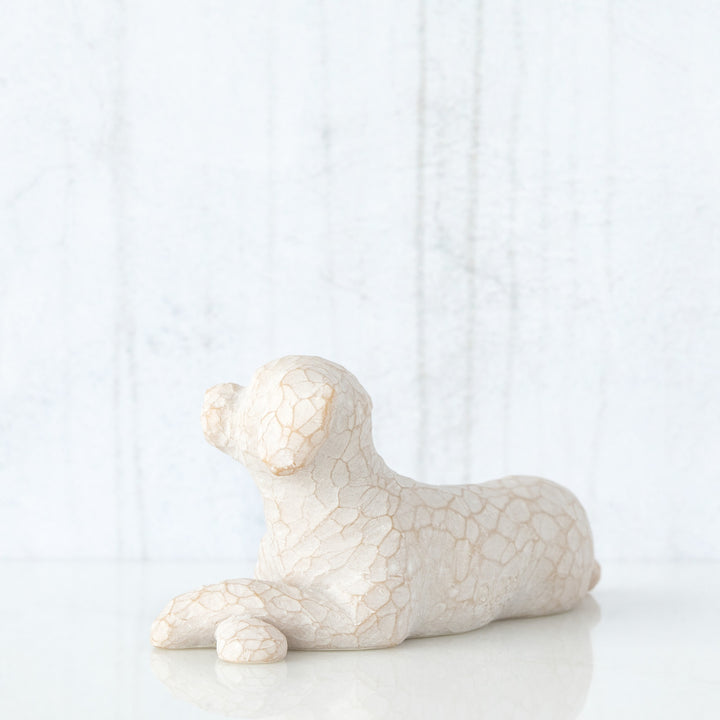 SMALL LYING WHITE DOG