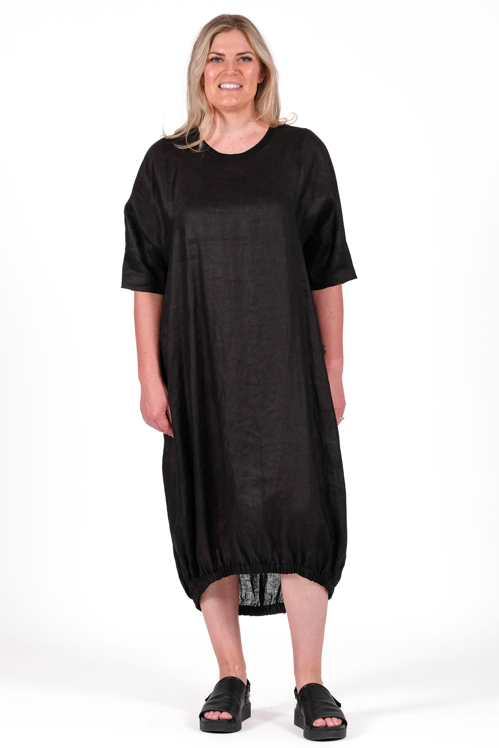 Woman wearing a black dress on a white background