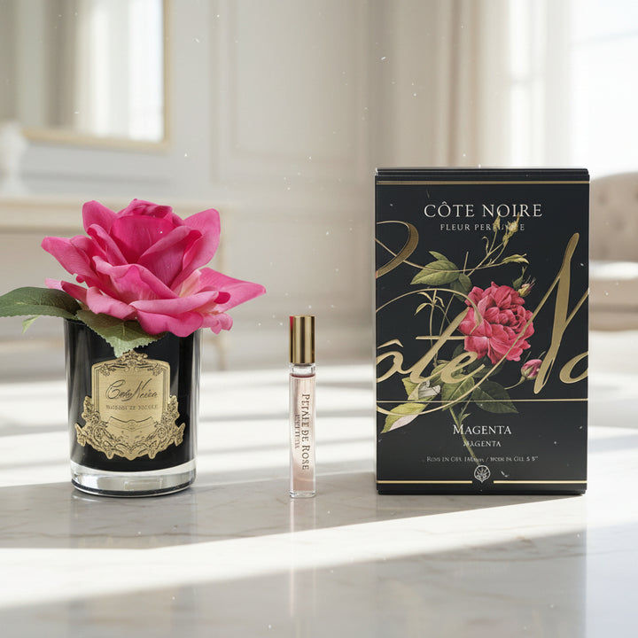 Cote Noire perfume set with a pink rose on a white background