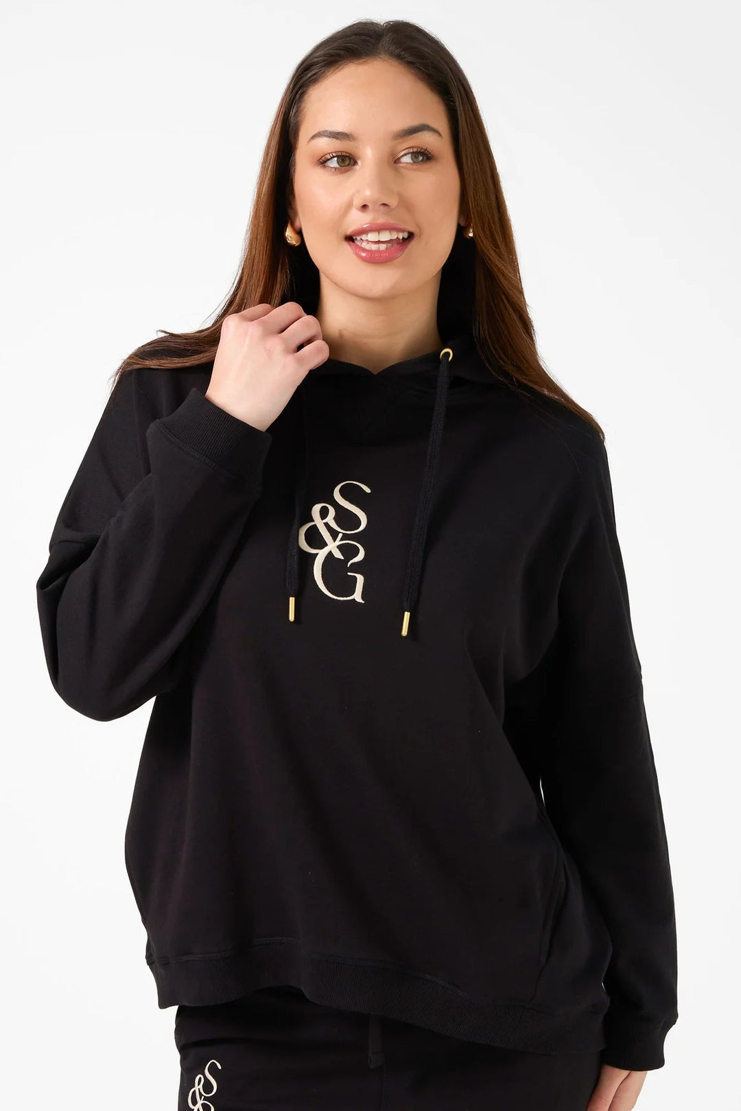 Person wearing a black hoodie with a logo on a white background