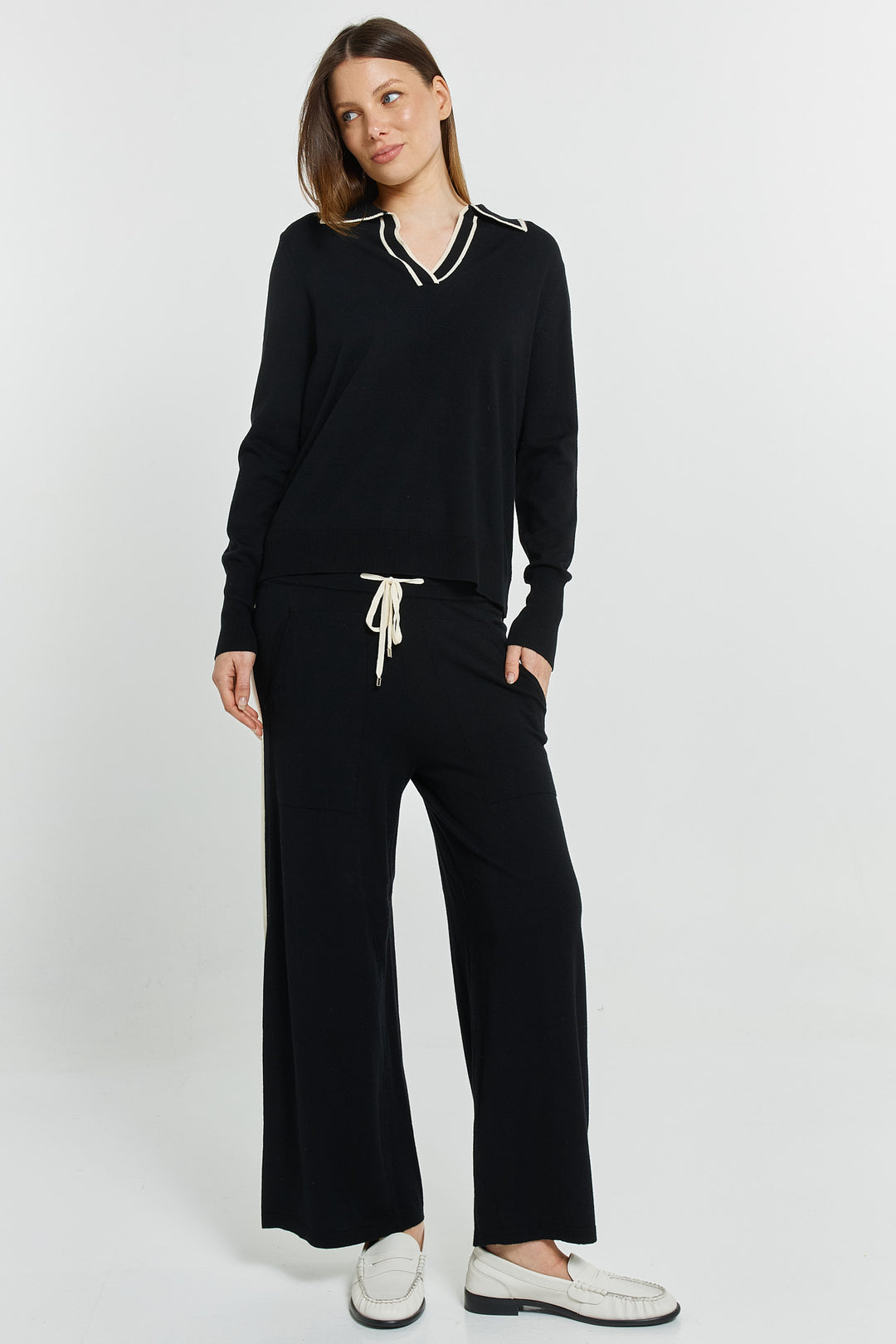 lady wearing black and white knit pant with matching top