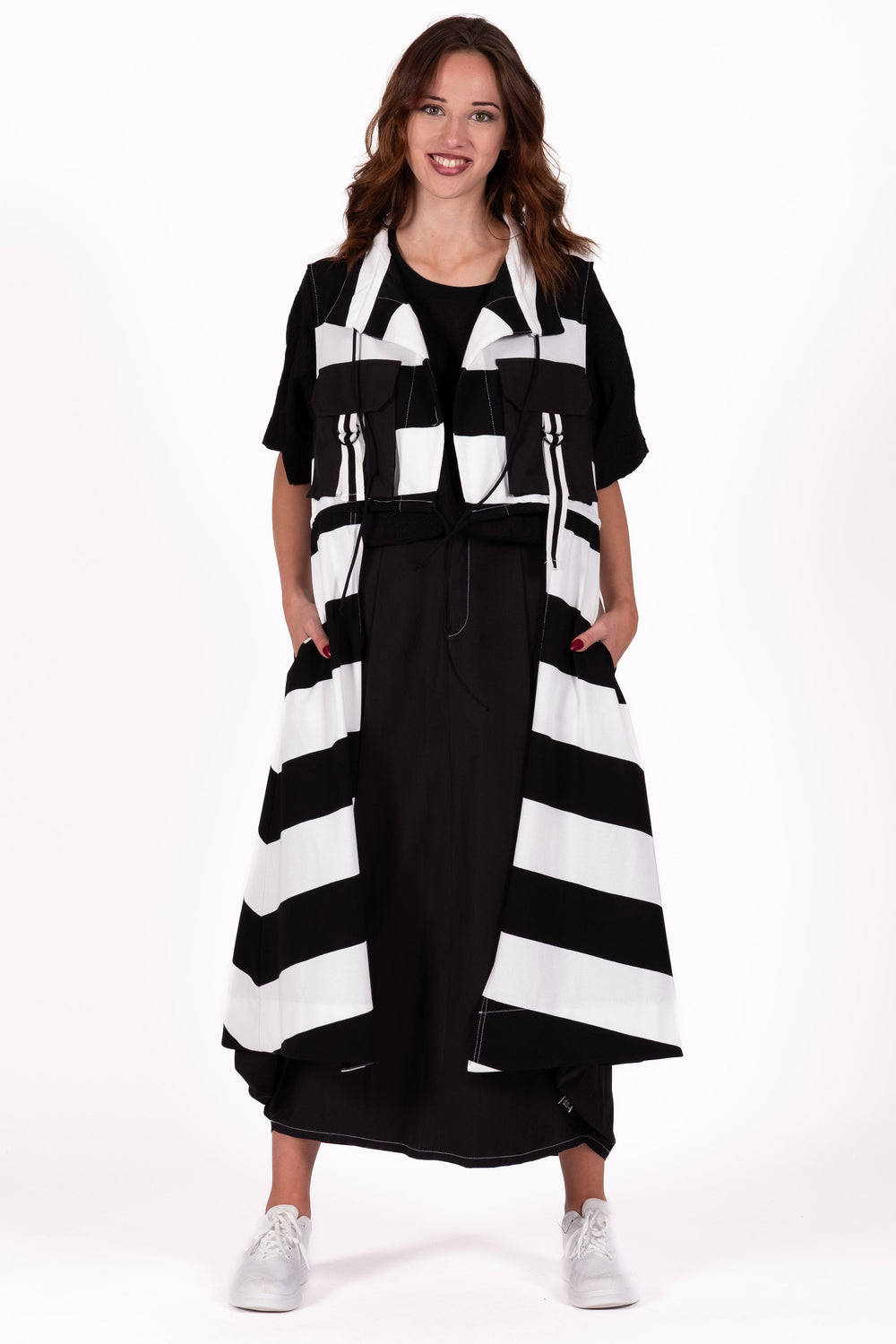 Woman wearing a black and white striped dress on a white background