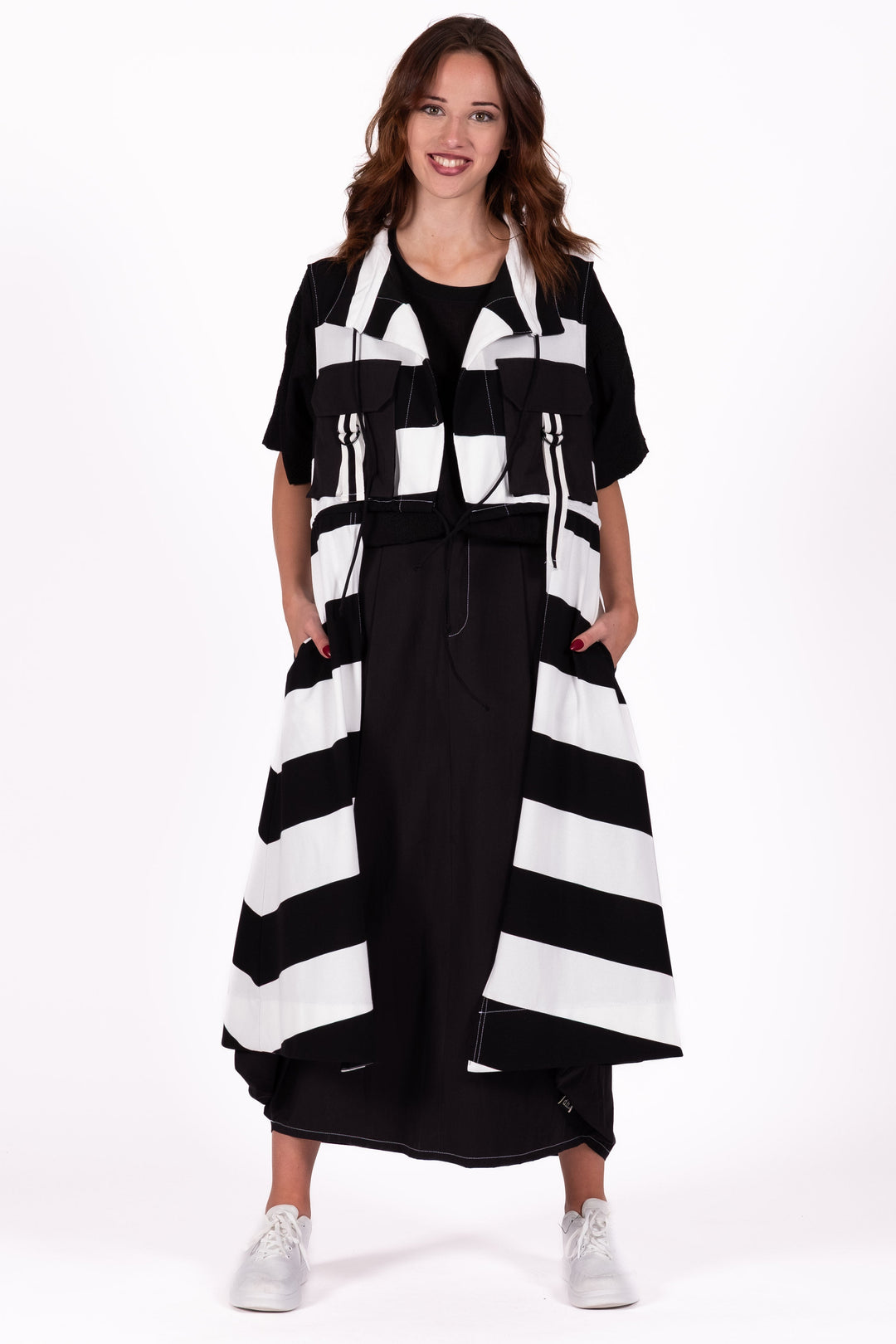 Woman wearing a black and white striped dress on a white background