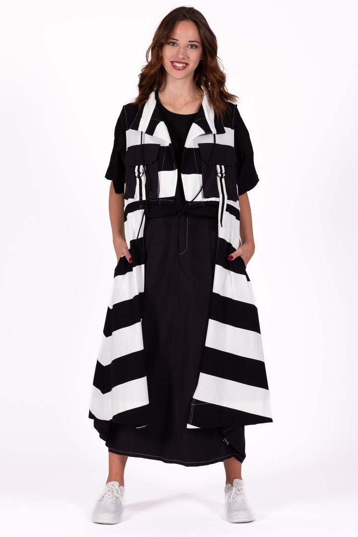 Woman wearing a black and white striped dress on a white background