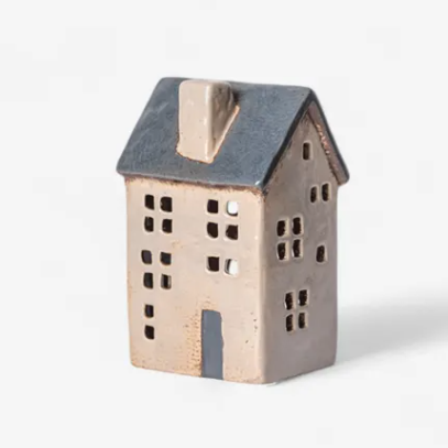 Small ceramic house-shaped object on a white background