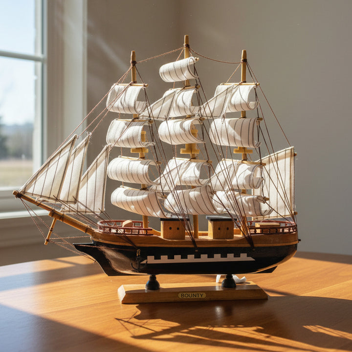Model ship with white sails on a white background