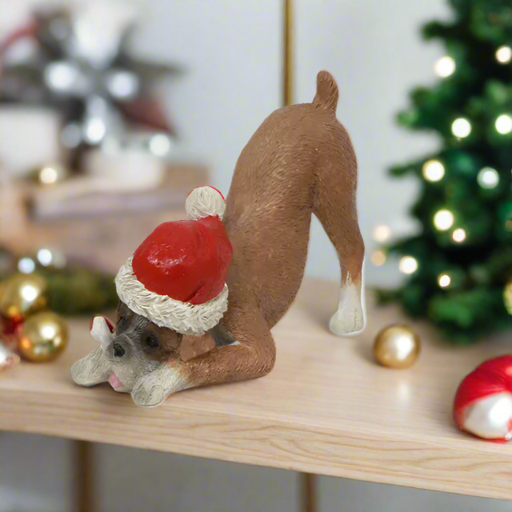 Dog figurine wearing a Santa hat on a white background
