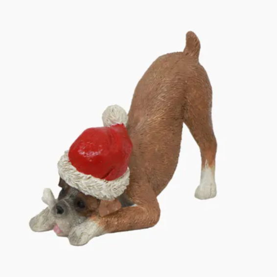 Dog figurine wearing a Santa hat on a white background