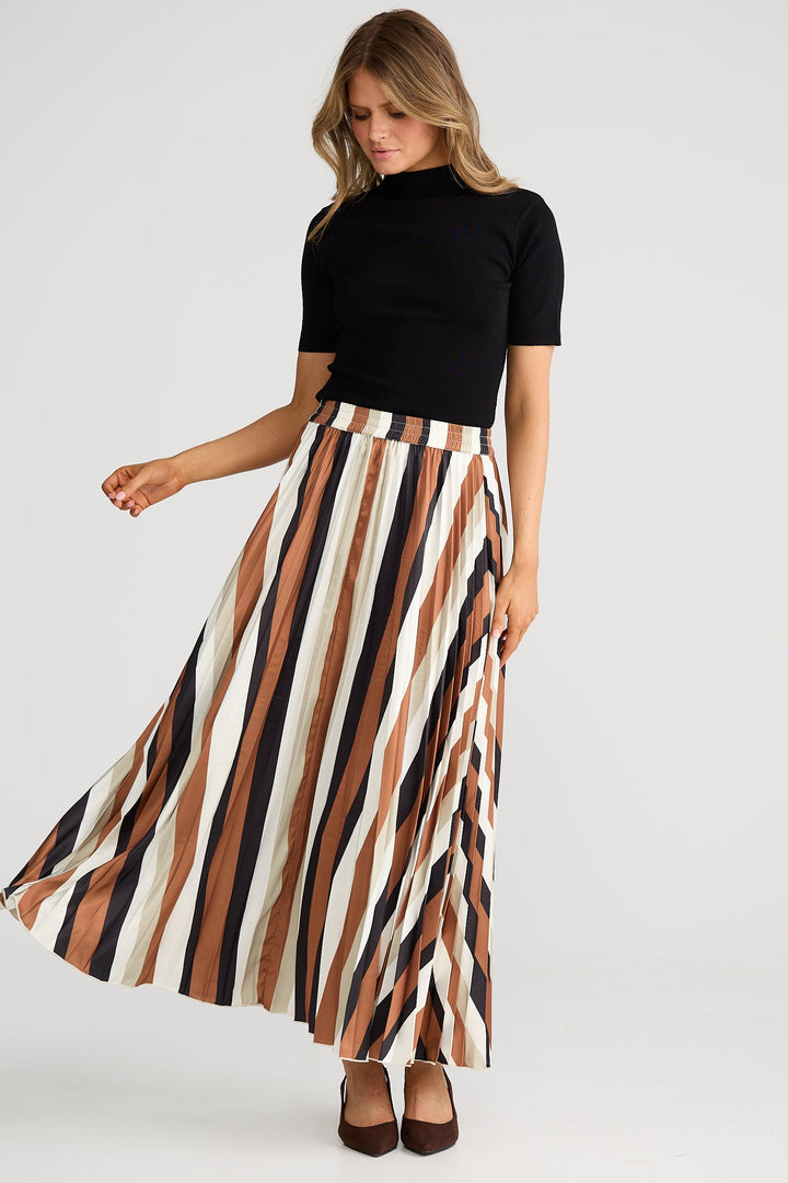 Woman wearing a black top and striped skirt on a white background