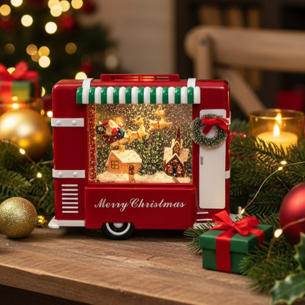 Red Christmas-themed snow globe with Santa Claus, reindeer, and a house on a white background.