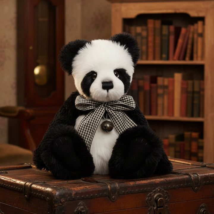 Stuffed panda bear with a bow tie on a white background