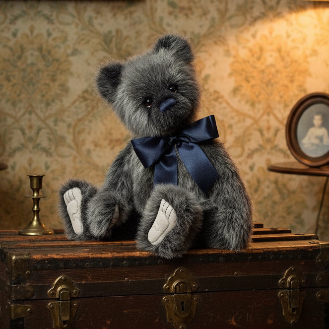Gray charlie bears collectable teddy bear with a navy blue bow tie on a white background