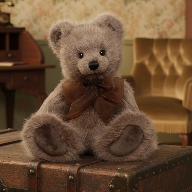 Brown teddy bear with a brown bow tie on a white background