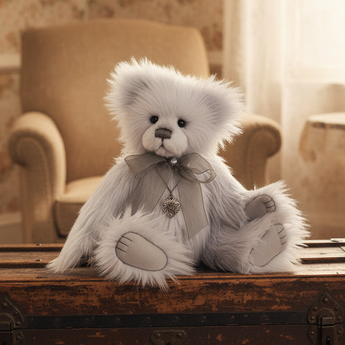 Gray charlie bears collectable teddy bear with a bow and heart charm on a white background