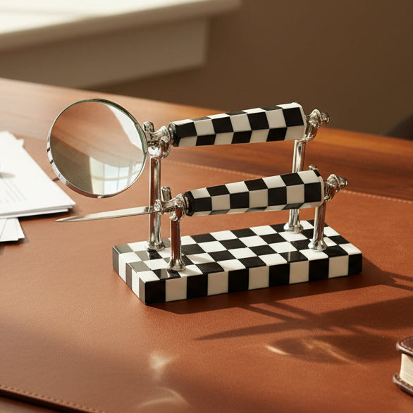 Checkered magnifying glass and knife set on a white background