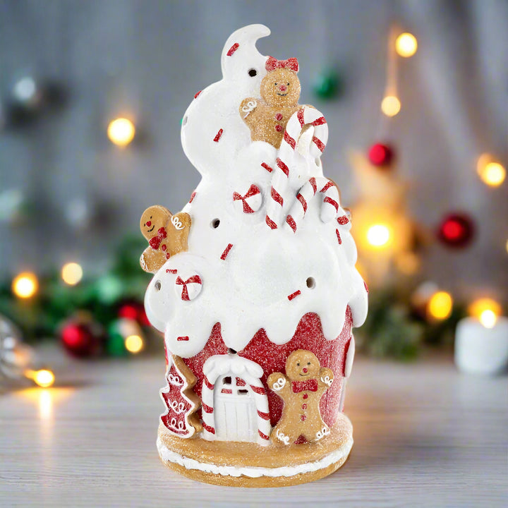 Decorative Christmas tree with gingerbread men, candy canes, and a snowman on a white background