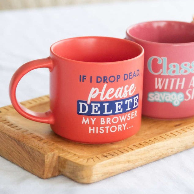 Three colorful mugs with humorous text on a wooden tray.