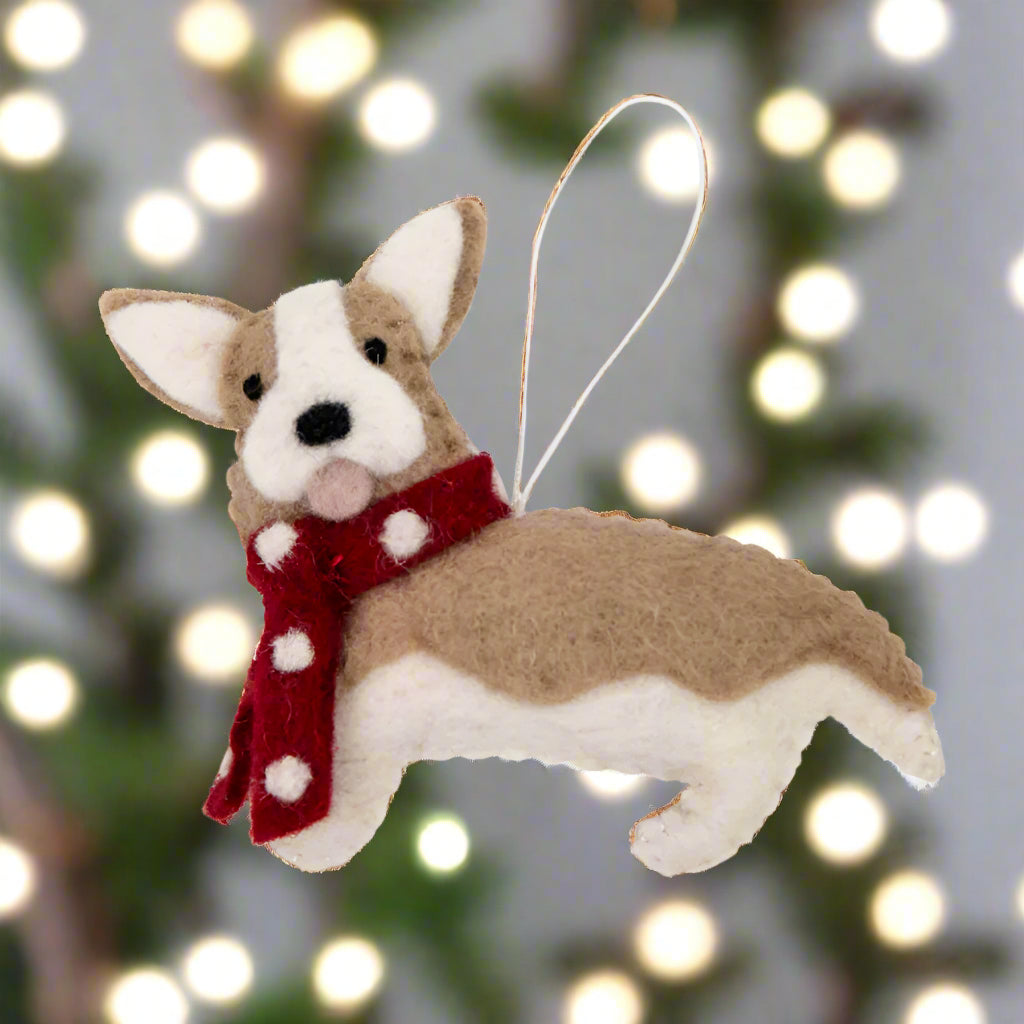 Felt dog ornament with a red scarf on a white background