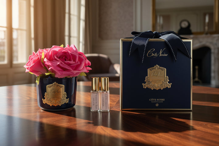 Cote Noir perfume set with a pink rose on a light gray background