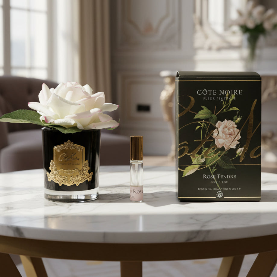 Cote Noire perfume set with a rose on a white background