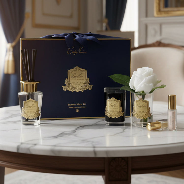 Set of luxury candles and diffuser with a branded box on a white background