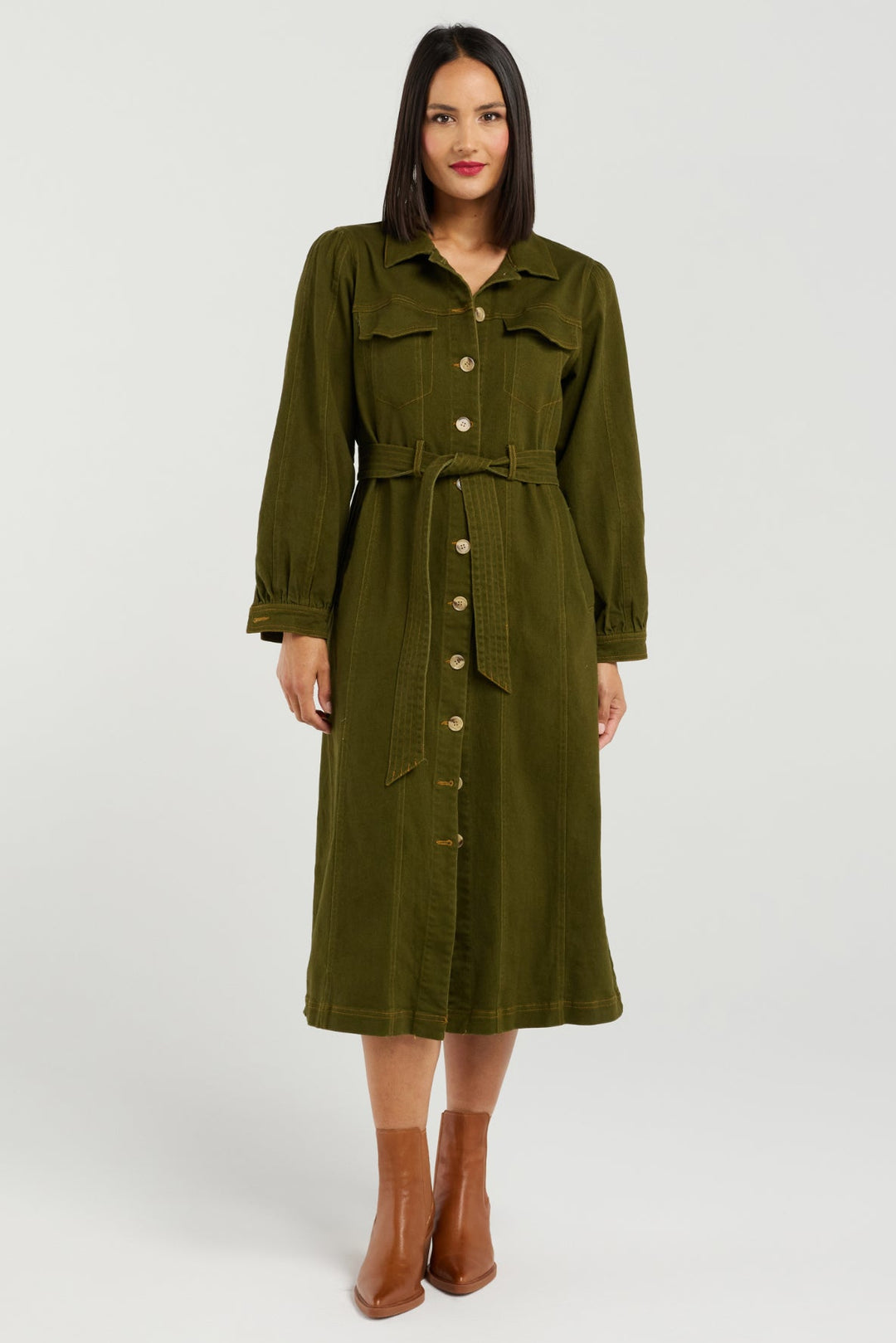 Woman wearing a green trench coat on a white background