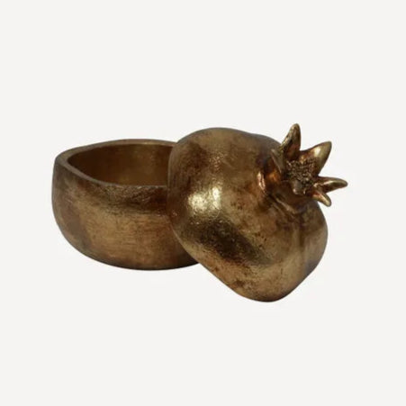 Bronze pomegranate-shaped container on a white background