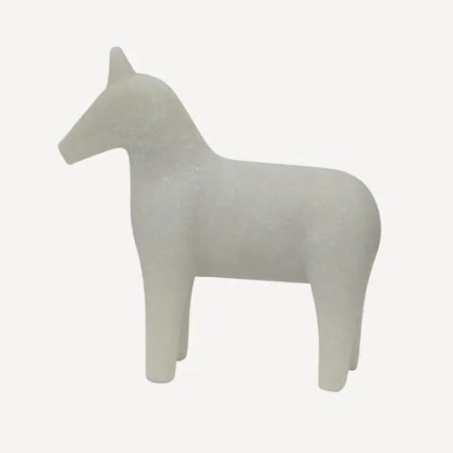 White horse-shaped object on a light gray background
