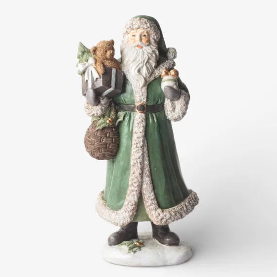Decorative figurine of a bearded man in a green coat holding a basket and a child on a white background