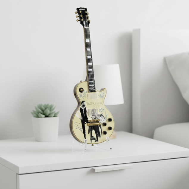 Miniatiure Guitar model with Fleetwood Mac album cover and signatures on a beige background