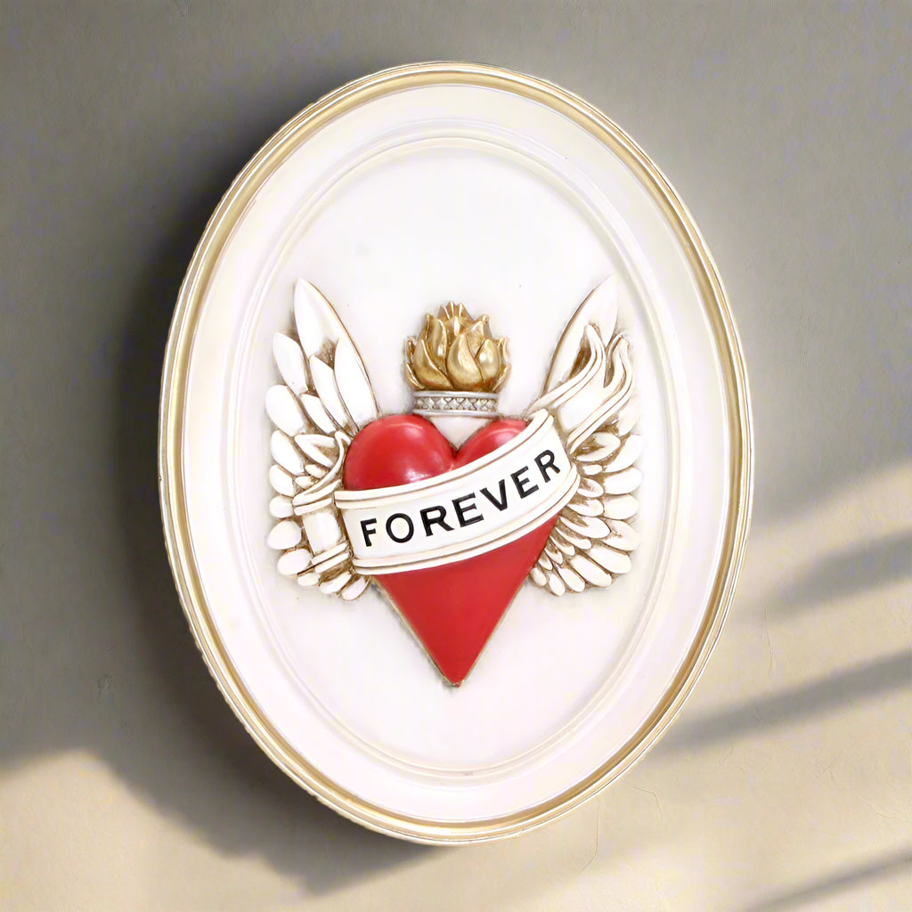 Decorative wall art with a red heart, wings, and 'FOREVER' text on a white background