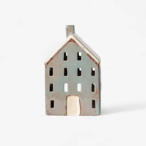 Ceramic house-shaped lantern on a white background