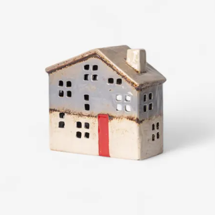 Ceramic house-shaped container with a red stripe on a white background