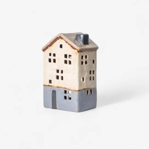 Ceramic house-shaped vase on a white background