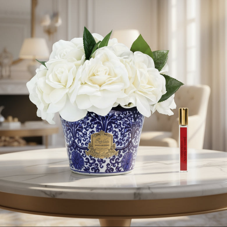 Cote Noire floral arrangement of Gardenias in a blue and white pot with a perfume for the flowers to diffuse the fragrance.