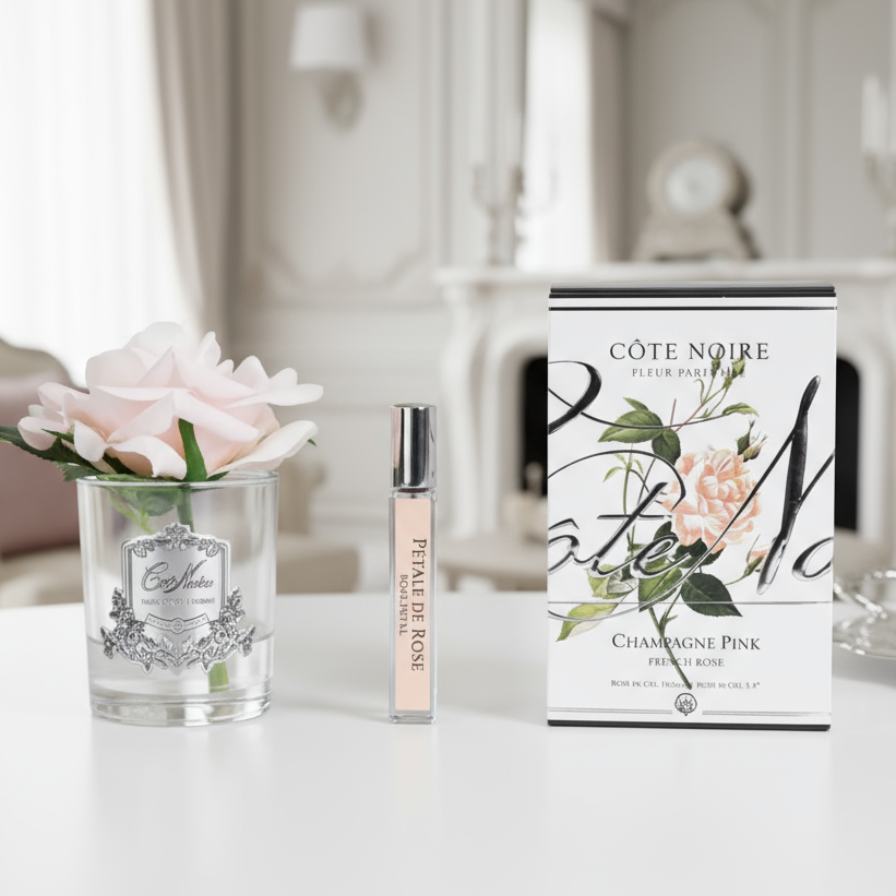 Cote Noire pink rose withperfume set with floral elements in a luxury background
