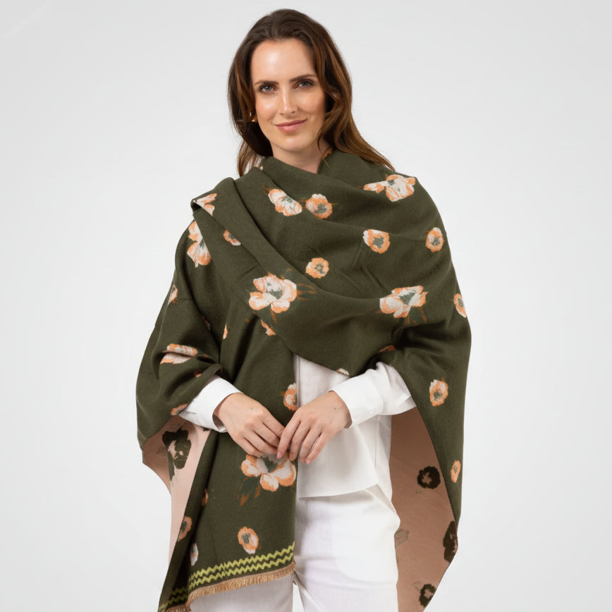 Woman wearing a green floral-patterned shawl on a white background