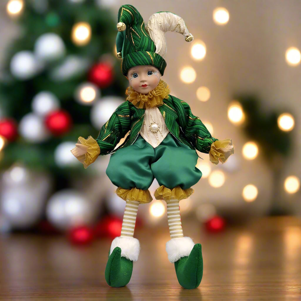 Elf doll in green and yellow outfit on a white background